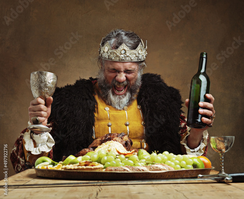 Im the life of the party. A mature king feasting alone in a banquet hall.