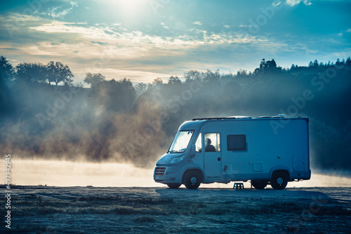 Rv caravan on lake shore. Autumn time, foggy morning