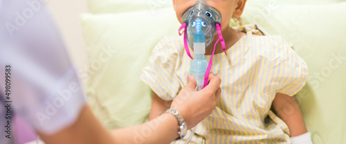 Nurse treat patient boy by inhalation therapy for RSV virus