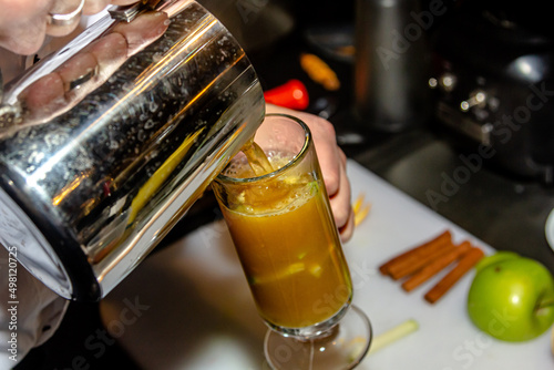 The bartender at the bar prepares orange grog