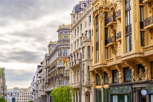 Facades of neoclassical buildings on Madrid's Gran Via at dawn.