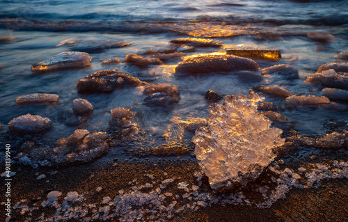 Close-up of piece of ice on snowy beach of Baltic sea at winter. Long exposure.