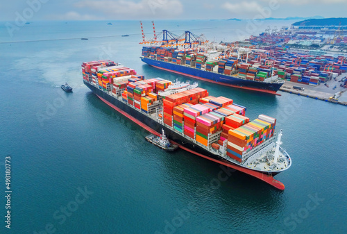 cargo ship and truck at seaport waiting for container dock crane shipment harbor loading container import and export commercial trade business logistic and transportation international.