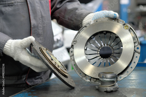 Spare parts for cars. Car clutch kit. An auto mechanic monitors the compliance and integrity of the drive disc, the driven disc and the exhaust bearing.