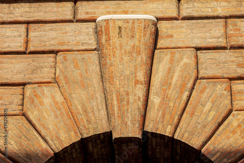 Close-up of a medieval arch made of bricks with keystone with the rusticated wall or ashlar (Bugnato in Italian), in Treviso downtown, Veneto, Italy, Europe.