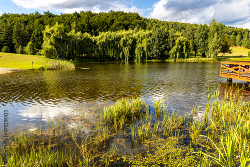 Panoramic view of Jezioro Wegleszynskie lake with wooded shores and surrounding hills in Ostrzyce village in Kashubia near Szymbark town in Pomerania region of Poland