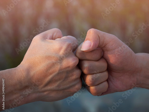 Close up of deal of teamwork with the Man hand a fist bump commit as get together in the office