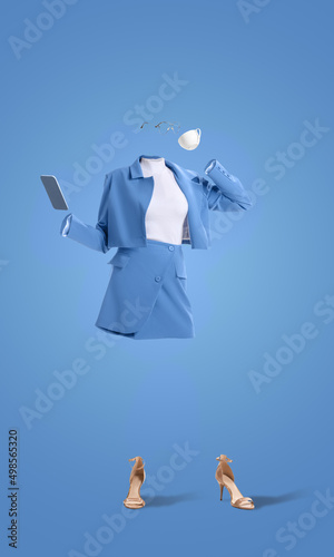 Creative portrait of invisible woman wearing modern business style blue outfit and heels drinking coffee on blue background. Concept of fashion, style