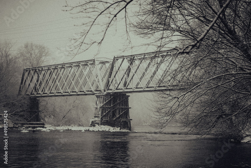 Grayscale shot of a bridge over a river in Menomonie, Wisconsin
