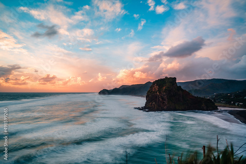 Scenic view of the rock formation and mountains against dusk sky, Piha Beach, Auckland, New Zealand