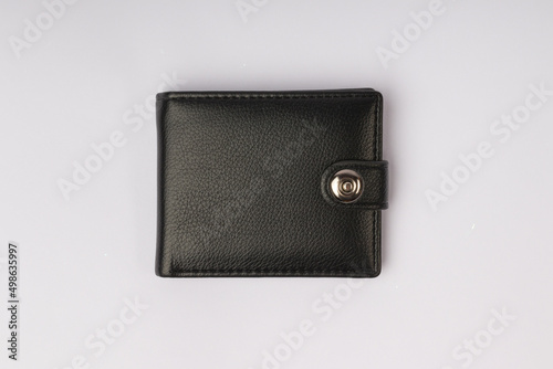 black leather wallet on a button on a white background, top view