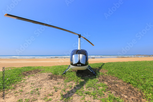Helicopter Robinson R44 landed on the beach