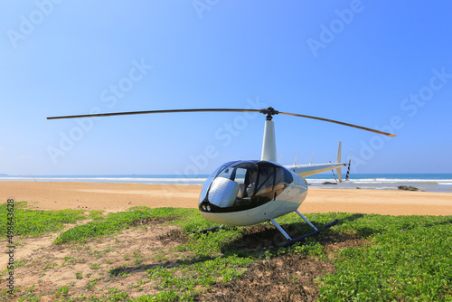 Helicopter Robinson R44 landed on the beach