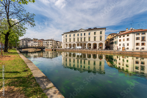 Cityscape of Treviso downtown with the river Sile with the street called Riviera Garibaldi and a small pedestrian bridge. Veneto, Italy, Europe.