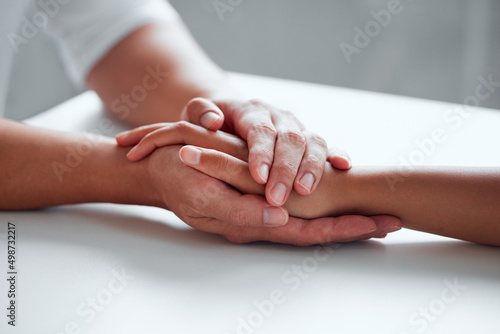 Kindness can change lives. Closeup shot of two unrecognisable people holding hands.