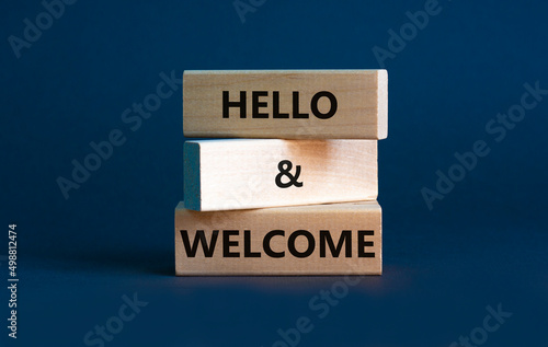 Hello and welcome symbol. Concept words Hello and welcome on wooden blocks. Beautiful grey background. Business hello and welcome concept. Copy space.