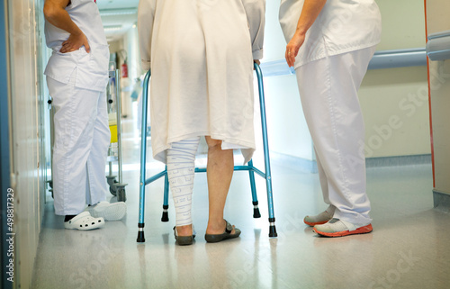 Two physiotherapists mobilize a patient in the intensive care unit.