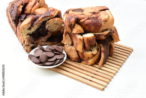 Large chocolate artisan bread, extra chocolate displayed on white wood