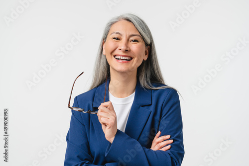 Laughing smiling caucasian mature middle-aged woman businesswoman teacher boss CEO tutor in formal suit and glasses looking at camera isolated in white background. Stomatology, dentistry concept