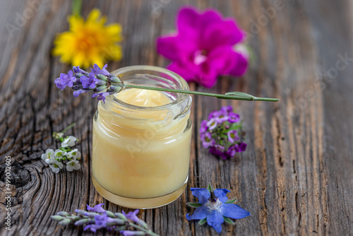 Jar of royal jelly (Food supplement) covered with a sprig of lavender.