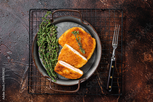 Cordon bleu chicken fillet cutlet with ham and cheese. Dark background. Top view