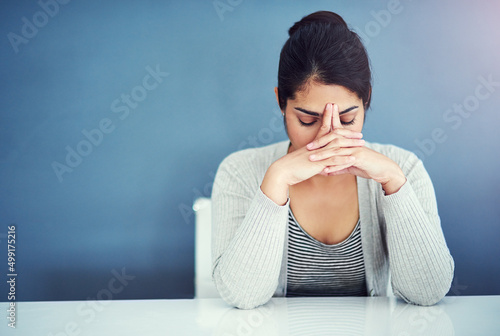 One headache after another. Shot of a businesswoman looking stressed at her desk.