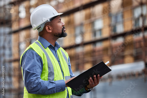 Always make sure of the rules. Shot of a contractor filling out paperwork at a construction site.