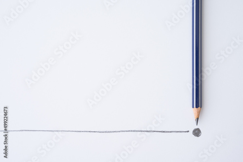Flat lay of blue pencil write line and end point on white paper background copy space. Business conclusion, creative idea, imagination and education concept.
