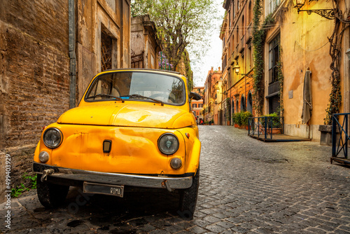 Vintage yellow car on the street of Rome, Italy. Rome architecture and landmark.