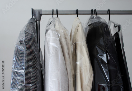 Rack with clean coats after dry cleaning on a dry cleaner.