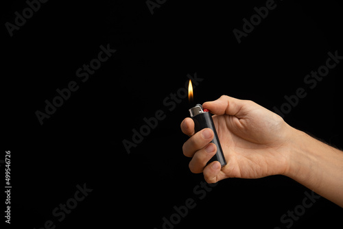 hand of a man handing a lit lighter