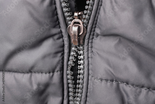 Close-up of a broken zipper on a jacket.