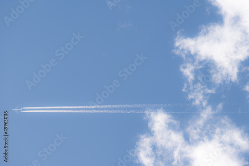 Distant airliner at high altitude against blue skies. 