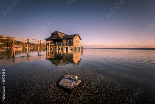 Traditional boathouse at lake Ammersee near Munich, Bavaria, Germany at sunrise.