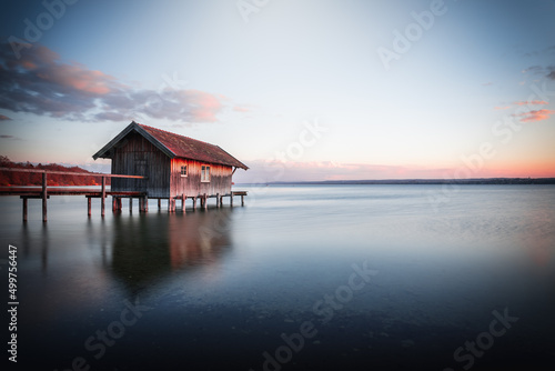 Traditional boathouse at lake Ammersee near Munich, Bavaria, Germany at sunrise.