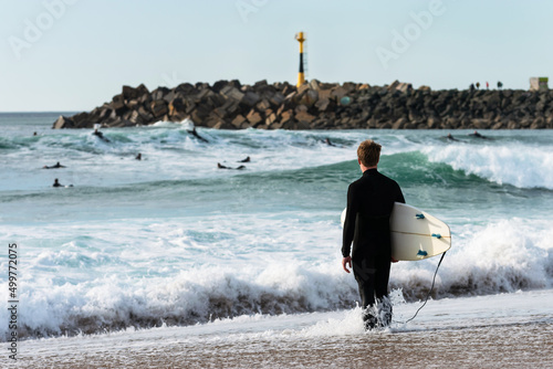 Surfer pondering his entrance to Les Cavaliers Beach. Anglet
