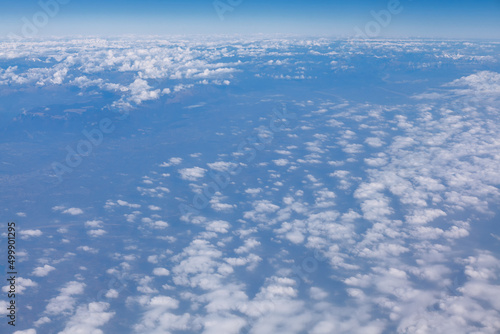 Above the altocumulus clouds . Flight over the earth 