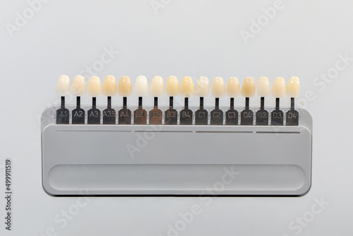 Palette of shades of teeth scale vita. A tool for teeth whitening isolate on a gray background.