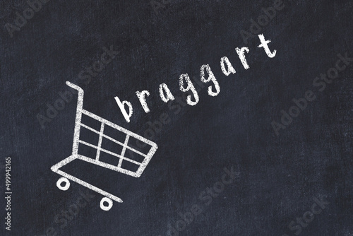 Chalk drawing of shopping cart and word braggart on black chalboard. Concept of globalization and mass consuming