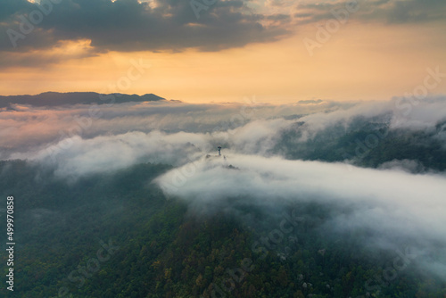 Aerial view fog in the forest and mountains and the transmission towers. Repeater station.