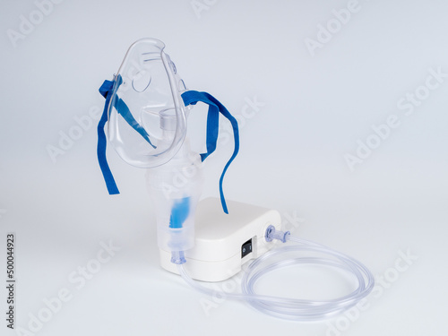 Medical equipment for inhalation with respiratory mask, nebulizer on a white background. Respiratory medicine. Asthma breathing treatment. Bronchitis, asthmatic health equipment