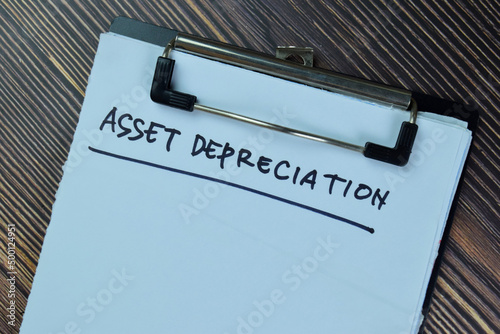 Asset Depreciation write on a paperwork isolated on Wooden Table.