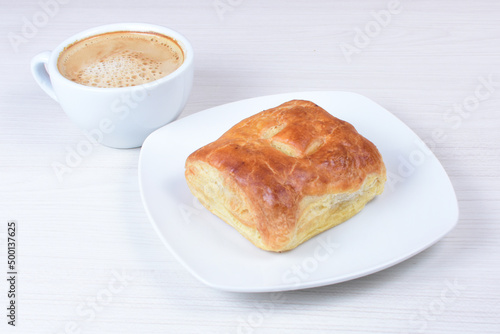 Ham and corn puff pastry, accompanied by sauce on a wooden background