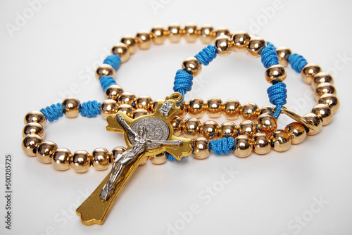 Male Christian rosary for prayer on a white background