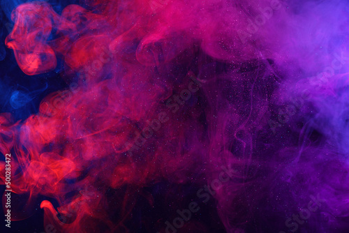 Colorful smoke clouds and shiny glitter particles abstract universe background