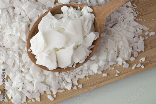 Soy wax - ingredient for handmade candles on wooden spoon