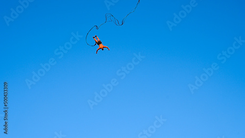 Bungee jumping. Young man is jumping from crane. Jump off a crane with a rope. Man having a good time bungee jumping. Extreme sport.