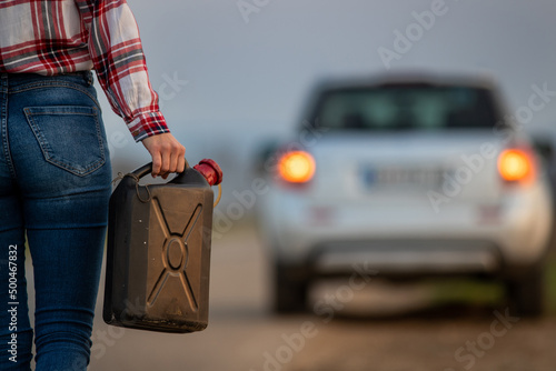 Close up of a woman holding fuel canister.