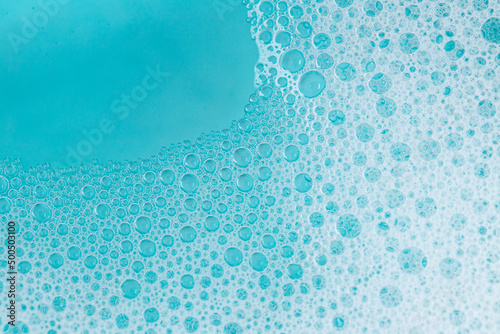 foam bubbles.Blue water with white foam bubbles.Foam Water Soap Suds. blue soap bubbles background.