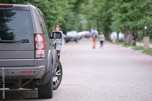 Close up of a car parked on city street side. Urban traffic concept